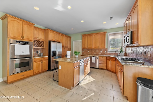 10 Emma Ln, Jackson, NJ 08527 - kitchen featuring stainless steel appliances, a kitchen island, tasteful backsplash, a breakfast bar area, and light stone counters