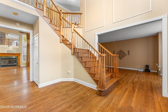 10 Emma Ln, Jackson, NJ 08527 - stairs featuring wood finished floors, baseboards, a high end fireplace, and a towering ceiling