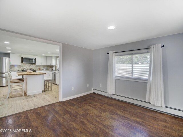 30 Mountain Ave, Hazlet, NJ 07730 - unfurnished living room with light wood-style flooring, a baseboard radiator, recessed lighting, and baseboards