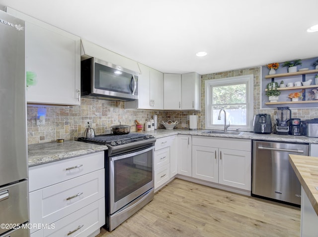 30 Mountain Ave, Hazlet, NJ 07730 - kitchen with appliances with stainless steel finishes, a sink, tasteful backsplash, light wood finished floors, and light stone counters
