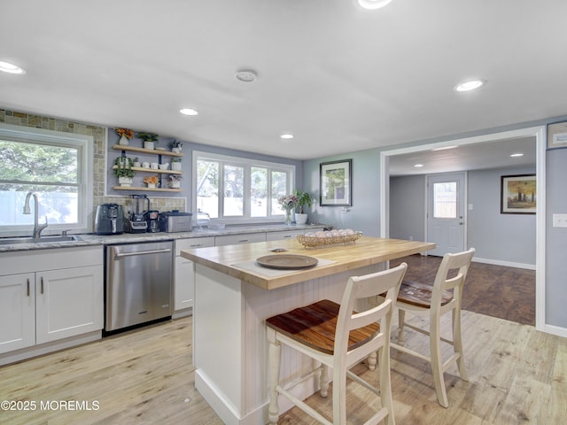 30 Mountain Ave, Hazlet, NJ 07730 - kitchen featuring stainless steel dishwasher, a sink, light wood-style floors, a kitchen bar, and white cabinets