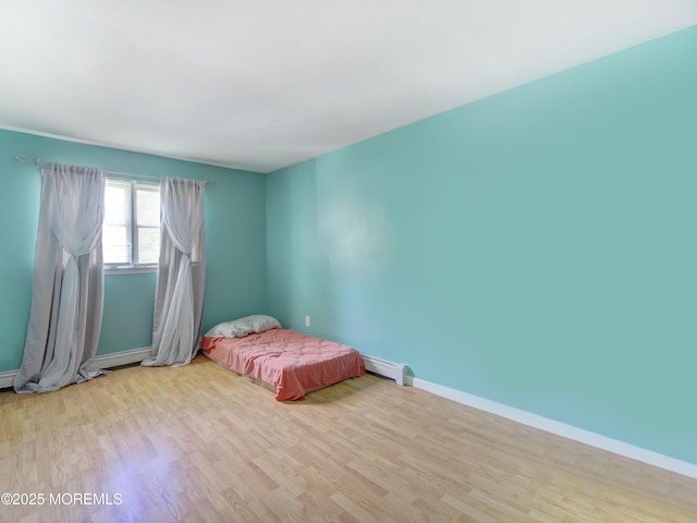 30 Mountain Ave, Hazlet, NJ 07730 - unfurnished bedroom featuring wood finished floors, baseboards, and a baseboard heating unit