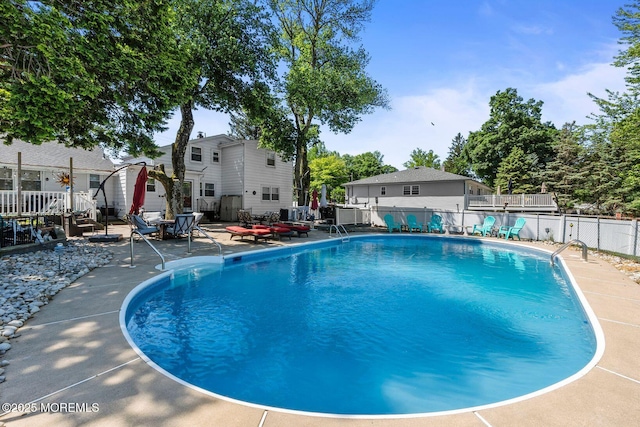 21 Wickatunk Rd, Manalapan, NJ 07726 - view of swimming pool featuring a patio and a wooden deck