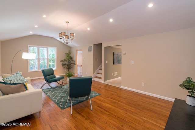 21 Wickatunk Rd, Manalapan, NJ 07726 - living area with lofted ceiling, a chandelier, baseboards, light wood finished floors, and stairway