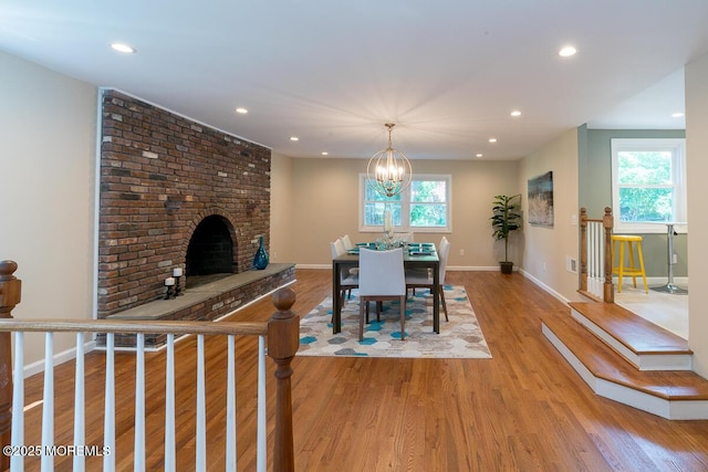 21 Wickatunk Rd, Manalapan, NJ 07726 - dining area featuring a brick fireplace, recessed lighting, light wood-type flooring, plenty of natural light, and baseboards