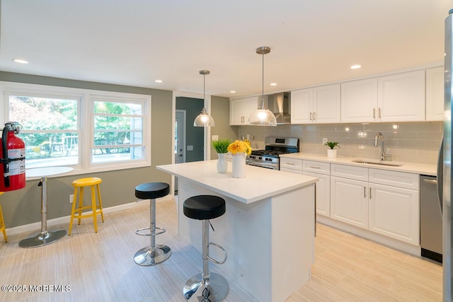21 Wickatunk Rd, Manalapan, NJ 07726 - kitchen with stainless steel appliances, a sink, wall chimney exhaust hood, white cabinetry, and recessed lighting
