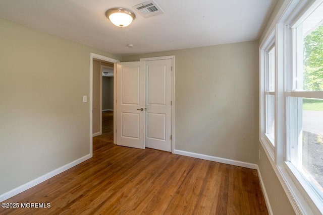 21 Wickatunk Rd, Manalapan, NJ 07726 - unfurnished bedroom with baseboards and wood finished floors