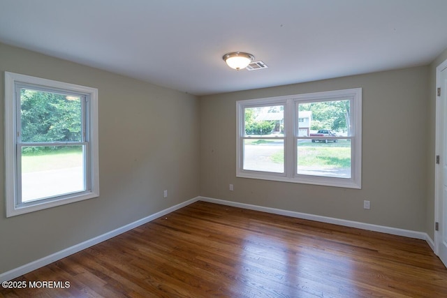 21 Wickatunk Rd, Manalapan, NJ 07726 - unfurnished room with healthy amount of natural light, wood finished floors, and baseboards
