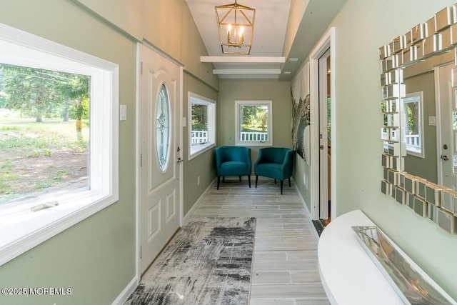 21 Wickatunk Rd, Manalapan, NJ 07726 - foyer with a chandelier, wood finished floors, baseboards, and lofted ceiling