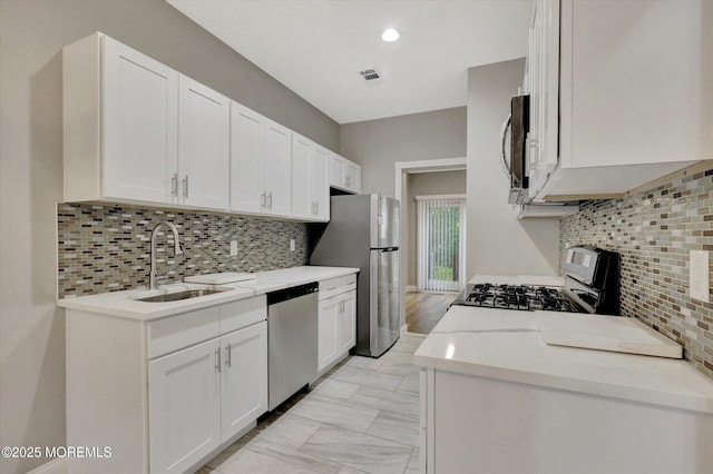 1103 Creamery Ct, Freehold, NJ 07728 - kitchen featuring stainless steel appliances, decorative backsplash, white cabinetry, and recessed lighting