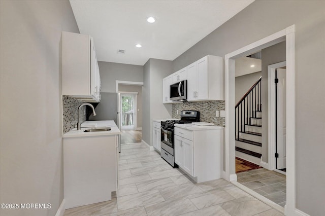 1103 Creamery Ct, Freehold, NJ 07728 - kitchen featuring stainless steel appliances, light countertops, decorative backsplash, white cabinetry, and recessed lighting