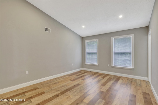 1103 Creamery Ct, Freehold, NJ 07728 - unfurnished room featuring light wood-style flooring, recessed lighting, and vaulted ceiling