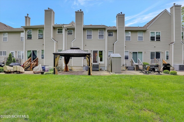 1103 Creamery Ct, Freehold, NJ 07728 - back of house featuring entry steps, a gazebo, a lawn, and a patio area