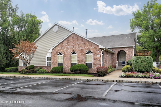 1103 Creamery Ct, Freehold, NJ 07728 - view of front of home with brick siding, uncovered parking, and roof with shingles