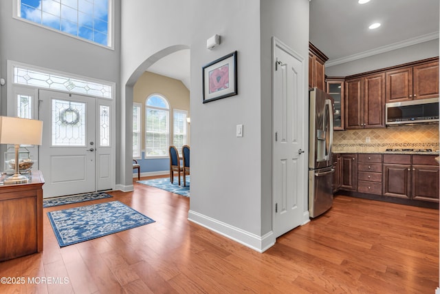 24 Beach Haven Way, Waretown, NJ 08758 - entrance foyer featuring arched walkways, baseboards, light wood finished floors, crown molding, and recessed lighting