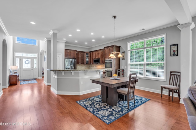 24 Beach Haven Way, Waretown, NJ 08758 - dining room featuring decorative columns, baseboards, plenty of natural light, arched walkways, and crown molding