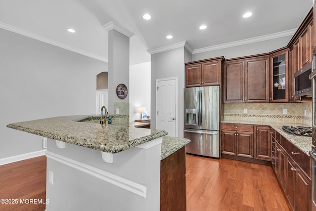24 Beach Haven Way, Waretown, NJ 08758 - kitchen with stainless steel appliances, arched walkways, wood finished floors, decorative backsplash, and recessed lighting