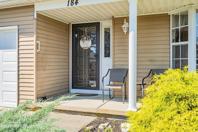 184 Pulaski Blvd, Toms River, NJ 08757 - view of exterior entry with a porch and a garage