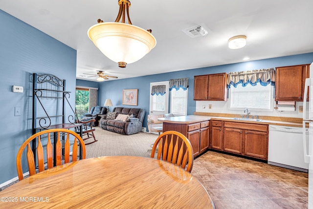184 Pulaski Blvd, Toms River, NJ 08757 - kitchen with dishwasher, brown cabinets, a peninsula, and a sink