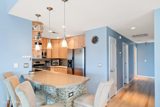 18 Sheridan Ave Unit 3, Seaside Heights, NJ 08751 - kitchen featuring appliances with stainless steel finishes, light brown cabinetry, backsplash, open shelves, and a peninsula