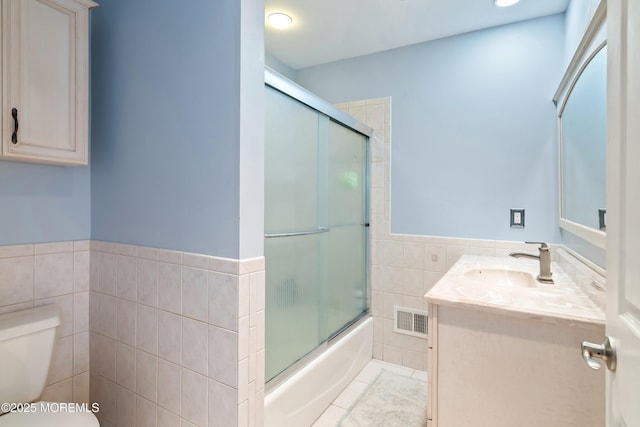 18 Sheridan Ave Unit 3, Seaside Heights, NJ 08751 - full bath with tile walls, toilet, vanity, enclosed tub / shower combo, and wainscoting