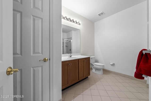 100 Middlesex Blvd Unit 144, Plainsboro, NJ 08536 - bathroom featuring vanity, a shower with door, toilet, tile patterned flooring, and baseboards