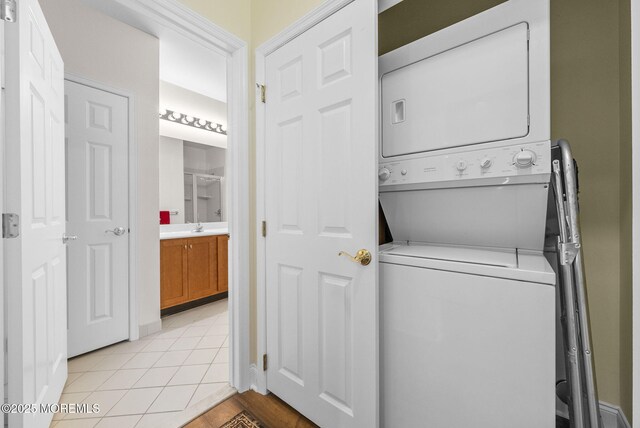 100 Middlesex Blvd Unit 144, Plainsboro, NJ 08536 - laundry area featuring stacked washer / drying machine, a sink, and light tile patterned flooring