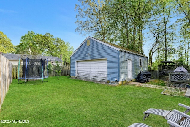 33 Cumberland Dr, Brick, NJ 08723 - view of yard featuring a trampoline, a detached garage, and an outbuilding