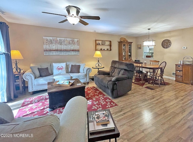 69 Bradford Ct, Aberdeen, NJ 07747 - living area with wood finished floors, a ceiling fan, and baseboards
