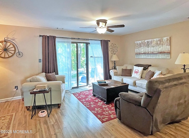 69 Bradford Ct, Aberdeen, NJ 07747 - living room featuring a ceiling fan, light wood finished floors, and baseboards