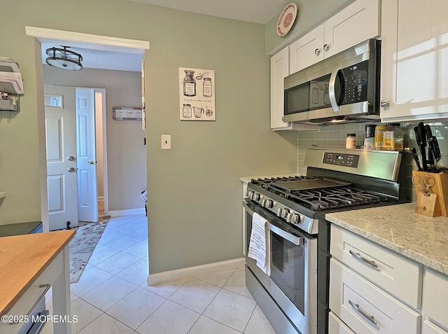 69 Bradford Ct, Aberdeen, NJ 07747 - kitchen featuring stainless steel appliances, tasteful backsplash, white cabinets, and baseboards
