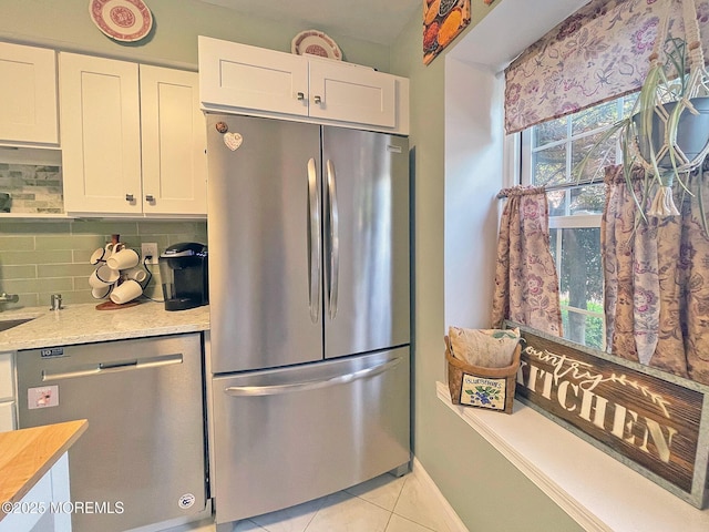 69 Bradford Ct, Aberdeen, NJ 07747 - kitchen featuring stainless steel appliances, white cabinetry, light tile patterned floors, and decorative backsplash