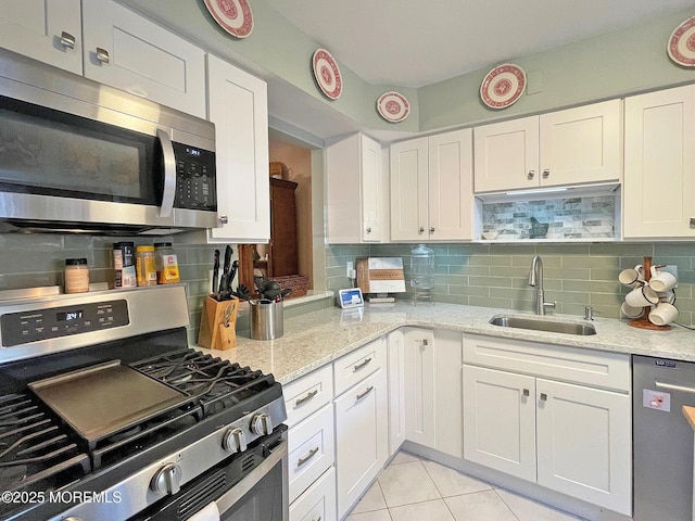 69 Bradford Ct, Aberdeen, NJ 07747 - kitchen with appliances with stainless steel finishes, a sink, backsplash, and white cabinets