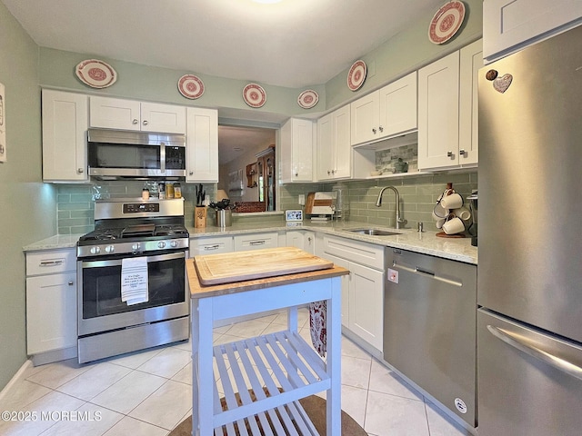 69 Bradford Ct, Aberdeen, NJ 07747 - kitchen featuring appliances with stainless steel finishes, a sink, tasteful backsplash, and white cabinets