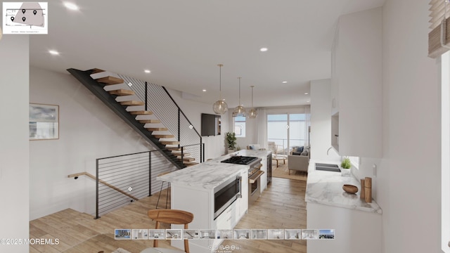 500 Ocean Ter Unit 1, Seaside Heights, NJ 08751 - kitchen with white cabinetry, light wood-style flooring, stainless steel microwave, a sink, and recessed lighting