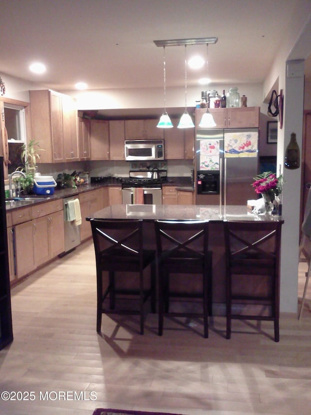 300 Lareine Ave, Bradley Beach, NJ 07720 - kitchen featuring appliances with stainless steel finishes, a sink, a breakfast bar area, and dark countertops