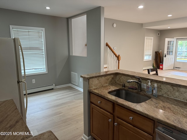 300 Lareine Ave, Bradley Beach, NJ 07720 - kitchen featuring freestanding refrigerator, a baseboard heating unit, stone countertops, light wood-style floors, and stainless steel dishwasher