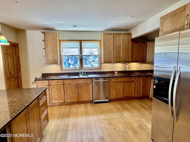 300 Lareine Ave, Bradley Beach, NJ 07720 - kitchen with appliances with stainless steel finishes, light wood-style flooring, brown cabinetry, and dark stone countertops