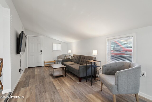 131 S Commodore Dr, Little Egg Harbor, NJ 08087 - living area featuring lofted ceiling, wood finished floors, healthy amount of natural light, and baseboards