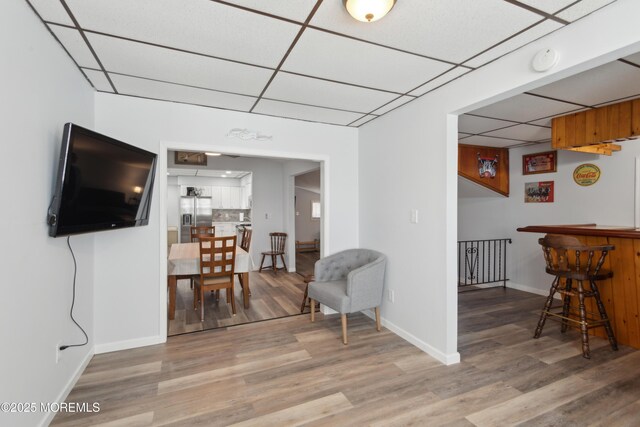 131 S Commodore Dr, Little Egg Harbor, NJ 08087 - living area featuring a paneled ceiling, light wood-type flooring, baseboards, and a dry bar