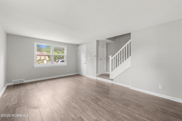 317 Bath Ave Unit 2, Long Branch, NJ 07740 - unfurnished living room featuring stairway, wood finished floors, and baseboards