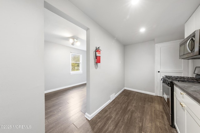 317 Bath Ave Unit 2, Long Branch, NJ 07740 - kitchen with appliances with stainless steel finishes, white cabinets, dark wood finished floors, and baseboards