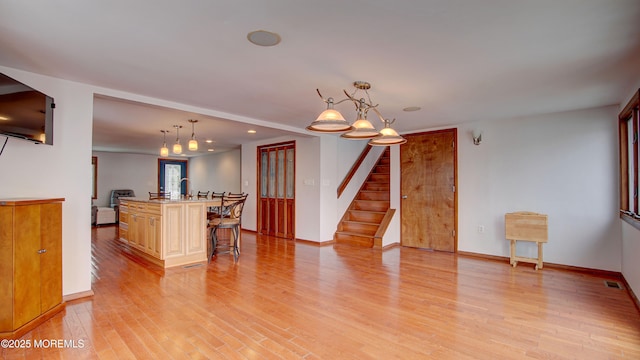 308 16th Ave, Belmar, NJ 07719 - kitchen featuring light wood-type flooring, a kitchen bar, a center island with sink, recessed lighting, and hanging light fixtures