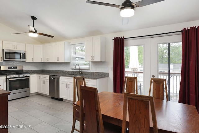 1117 Ruby Dr, Toms River, NJ 08753 - kitchen with stainless steel appliances, a ceiling fan, a sink, tasteful backsplash, and vaulted ceiling
