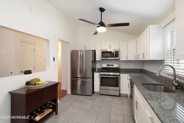 1117 Ruby Dr, Toms River, NJ 08753 - kitchen featuring stainless steel appliances, a sink, backsplash, white cabinets, and lofted ceiling