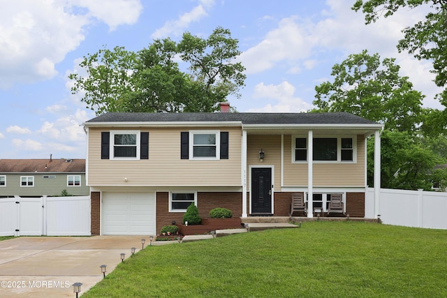 1117 Ruby Dr, Toms River, NJ 08753 - raised ranch with brick siding, driveway, an attached garage, and a chimney
