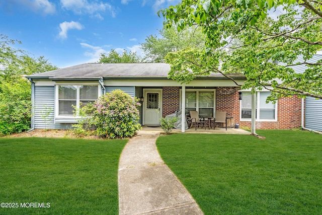 846 Winchester Ct Unit A, Manchester, NJ 08759 - view of front of home featuring a front lawn, a patio, brick siding, and roof with shingles