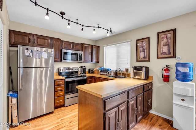 846 Winchester Ct Unit A, Manchester, NJ 08759 - kitchen with appliances with stainless steel finishes, a sink, a peninsula, light countertops, and light wood finished floors