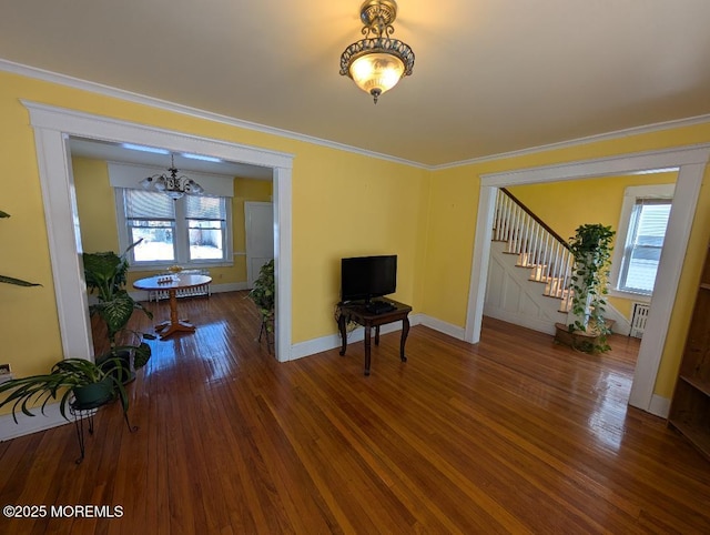 619 Leland Ave, Plainfield, NJ 07062 - living area with healthy amount of natural light, a chandelier, stairway, wood finished floors, and ornamental molding