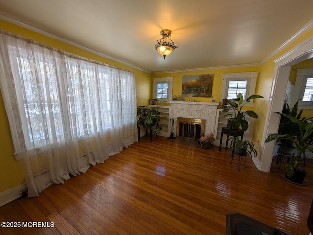 619 Leland Ave, Plainfield, NJ 07062 - living room featuring hardwood / wood-style floors, a brick fireplace, ornamental molding, and baseboards